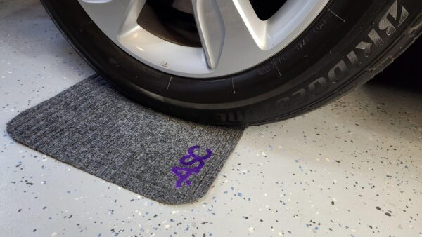 Car tire on mat